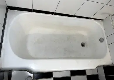 Rust-stained bathtub before refinishing process