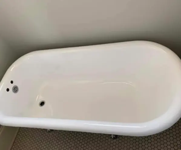 Restored clawfoot bathtub after reglazing with a brilliant glossy white finish and elegant look