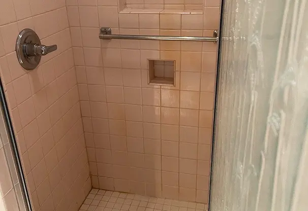 Before shower reglazing showing restored shine and smooth surface